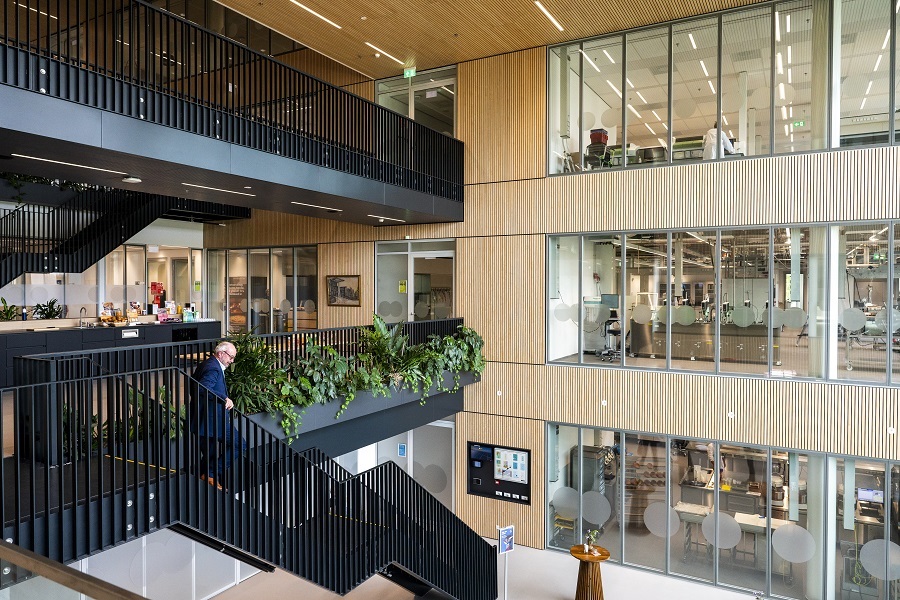 inside of a huge office building with black stairs